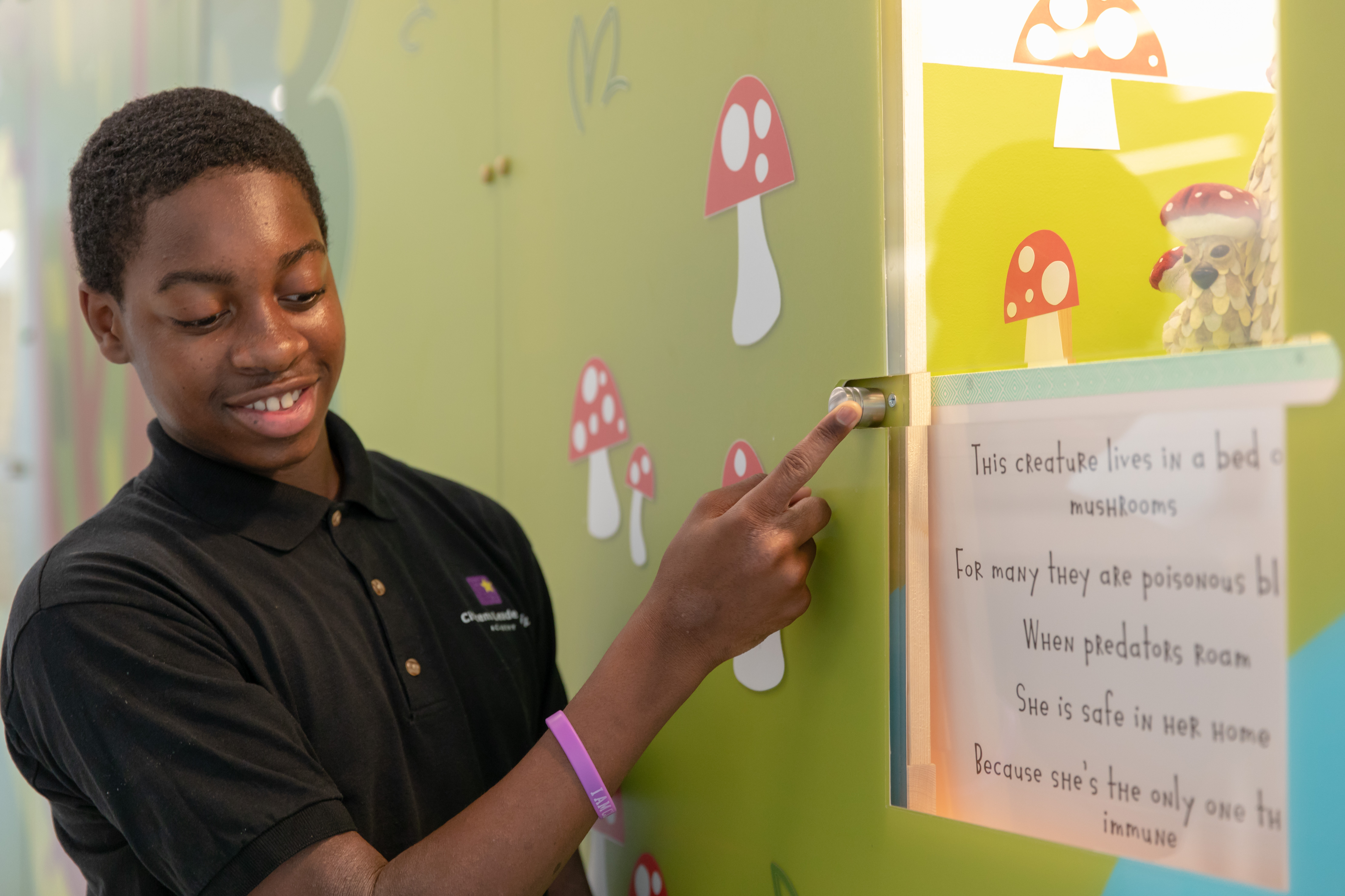Kid pointing at sign at ribbon cutting ceremony